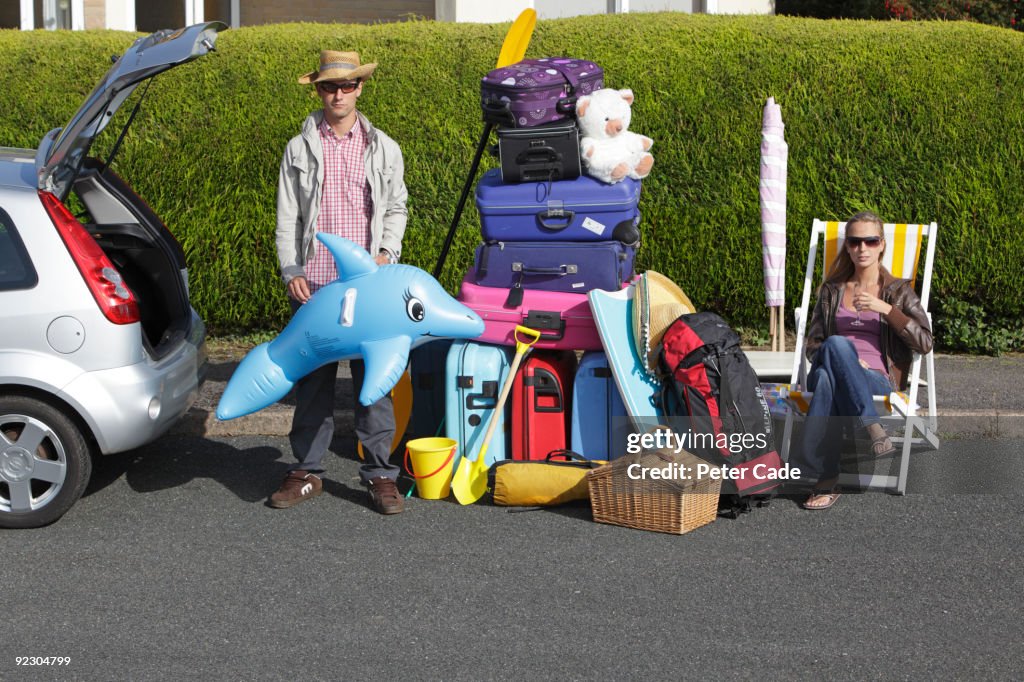 Couple loading car for holiday