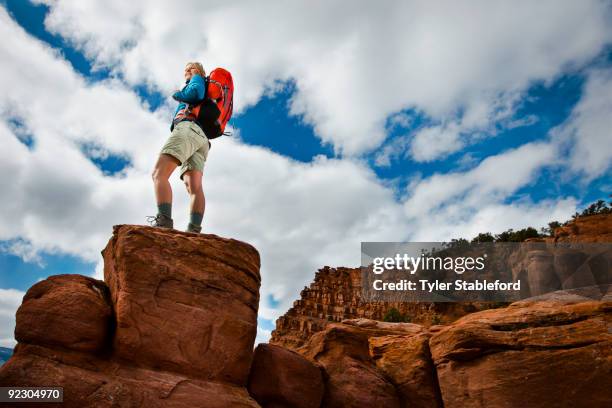 female hiker standing on rock near red cliffs. - carbondale colorado bildbanksfoton och bilder