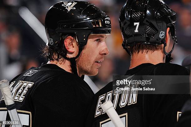 Defensemen Jay McKee and Mark Eaton, both of the Pittsburgh Penguins, communicate with each other before a face off against the St. Louis Blues on...