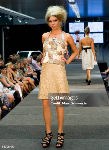 Model showcases a design on the catwalk by Isabella's Closet during the Sunshine Coast Fashion Festival at the Coastline BMW Showroom on October 23,...