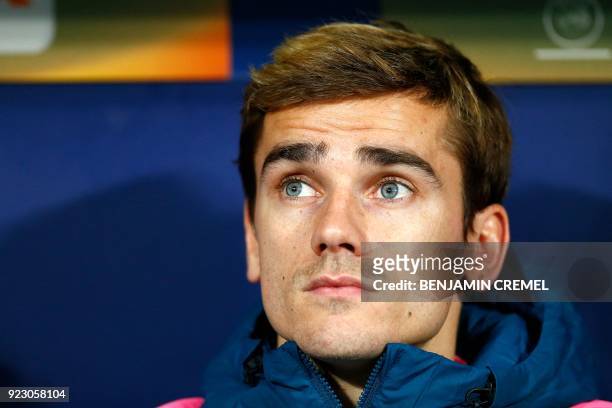 Atletico Madrid's French forward Antoine Griezmann sits on the bench before the Europa League Round of 32 second leg football match between Club...