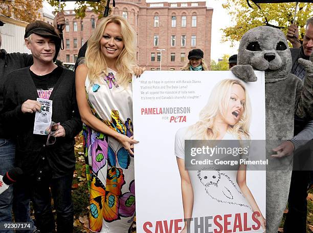 Designer Richie Rich and Pamela Anderson appear with a person dressed as a baby seal to unveil a new PETA campaign at the Ontario Legislative...