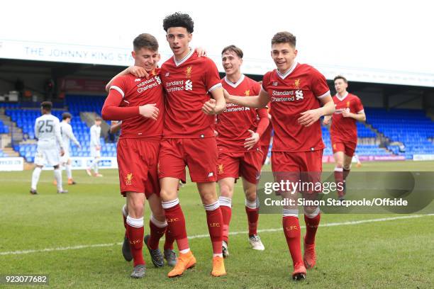 Ben Woodburn of Liverpool celebrates with teammates Curtis Jones and Adam Lewis after scoring their 1st goal during the UEFA Youth League Round of 16...