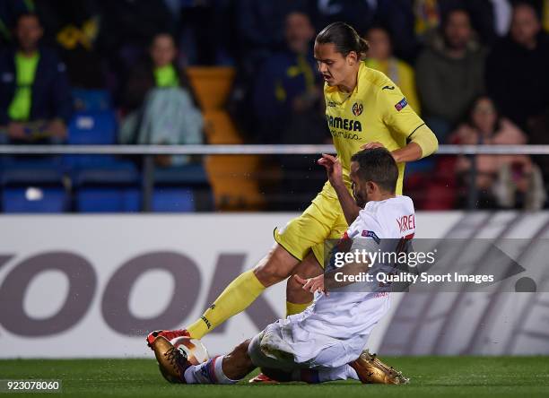 Enes Unal of Villarreal competes for the ball with Jeremy Morel of Olympique Lyon during UEFA Europa League Round of 32 match between Villarreal and...