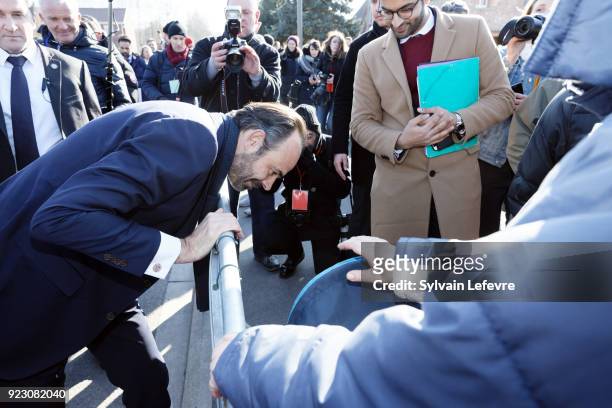 French Prime Minister Edouard Philippe speaks with people as he visits Northern France on February 22, 2018 in Pecquencourt near Douai, France.
