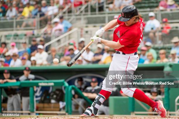 Brock Holt of the Boston Red Sox hits a single during a game against Northeastern University on February 22, 2018 at jetBlue Park at Fenway South in...