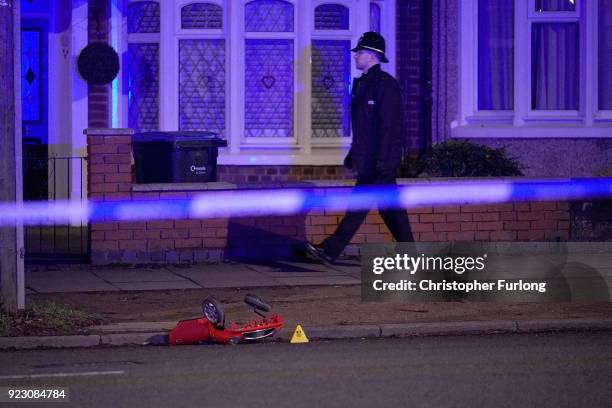 The remains of a toy car is marked by police accident markers after two brothers aged six and two died after a suspected hit-and-run crash on...