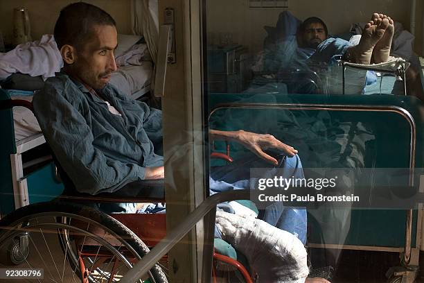 Mir Mohammed, an Afghan policeman rests in his wheelchair suffering from an infected amputated leg at the ANA Military hospital October 21, 2009...