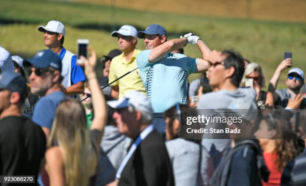 Rory McIlroy of Northern Ireland hits a tee shot as fans watch on the 15th hole during the third round of the Genesis Open at Riviera Country Club on...