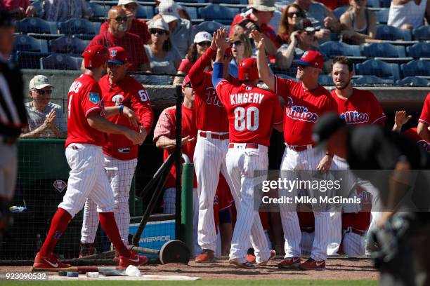 Scott Kingery of the Philadelphia Phillies and Adam Rosales celebrates outside the dugout after reaching on a 2 RBI single hit by Danny Ortiz against...