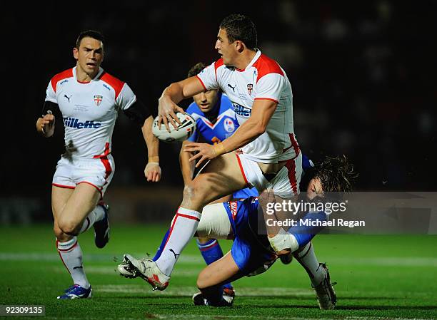 Kevin Sinfield of England is tackled by Sebastien Raguin of France during the Gillette Four Nations match between England and France at the Keepmoat...