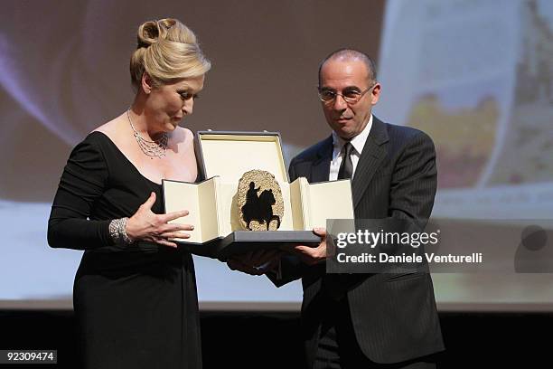 Actress Meryl Streep smiles as she receives The Golden Marc'Aurelio Acting Award from director Giuseppe Tornatore during the Official Awards Ceremony...