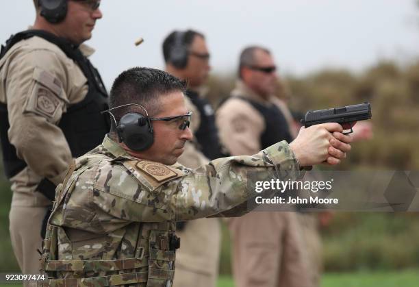 Customs and Border Protection agents fires a handgun at a shooting range on February 22, 2018 in Hidalgo, Texas. CBP agents must complete firearms...