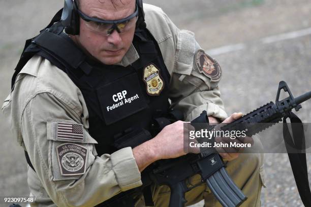 Customs and Border Protection agents prepare to fire M4 rifles during a qualification test at a shooting range on February 22, 2018 in Hidalgo,...