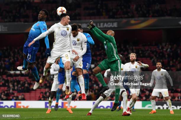 Aly Keita of Ostersunds FK comes to punch through a crowd of of players during UEFA Europa League Round of 32 match between Arsenal and Ostersunds FK...