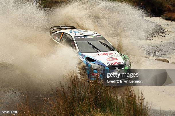 Mathew Wilson of Great Britain and the Stobart VK M-Sport Ford Rally Team drives through the water splash during stage 2 of the Wales Rally GB on...