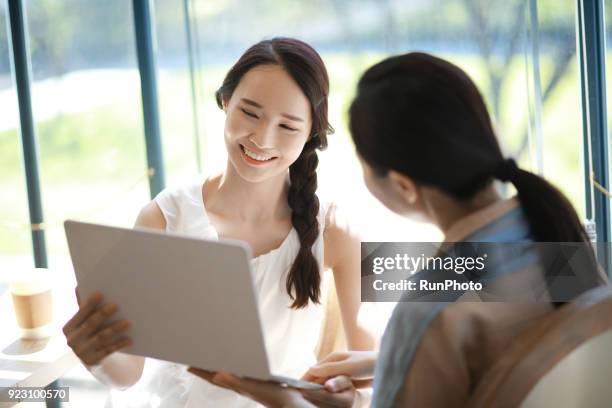 university professor and young student using laptop in cafe - korea university stock pictures, royalty-free photos & images