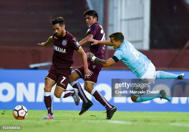 Lautaro Acosta of Lanus fights for the ball with Gabriel Costa of Sporting Cristal during a first leg match between Lanus and Sporting Cristal as...