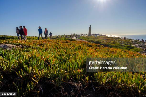 Tourists are seen on a sunny winter afternoon in Cabo da Roca on February 22, 2018 in Sintra, Portugal. Cabo da Roca is a cape which forms the...