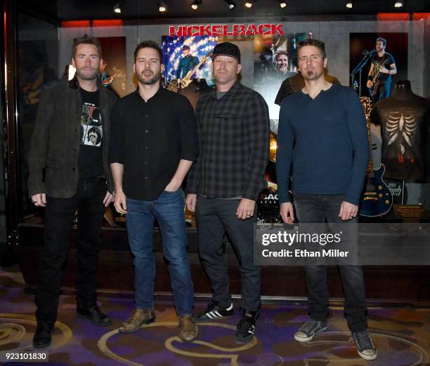 Frontman Chad Kroeger, guitarist Ryan Peake, bassist Mike Kroeger and drummer Daniel Adair of Nickelback attend a memorabilia case dedication ahead...