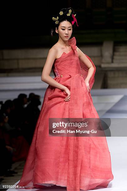 Model walks down the catwalk during the fashion show as part of the South Korean Traditional Costume 'HanBok' fashion show on October 23, 2009 in...