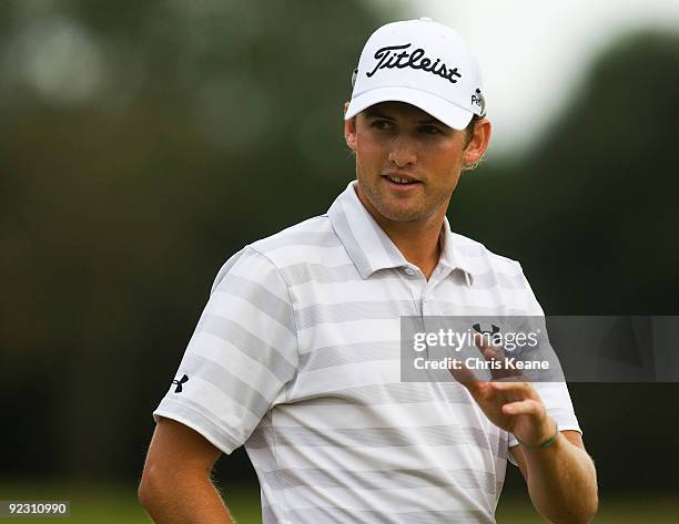 Michael Sim of Australia waves to the crowd after finishing the 18th hole during the second round of the Nationwide Tour Championship at Daniel...