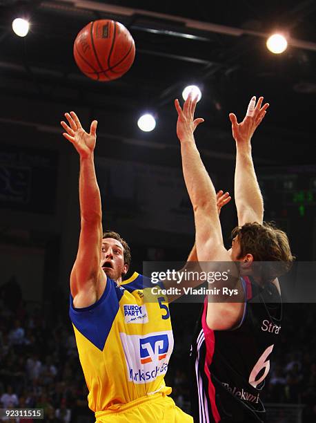 Chase Griffin of Phoenix shoots as Johannes Strasser of Baskets defends during the Beko Basketball Bundesliga game between Telekom Baskets and...