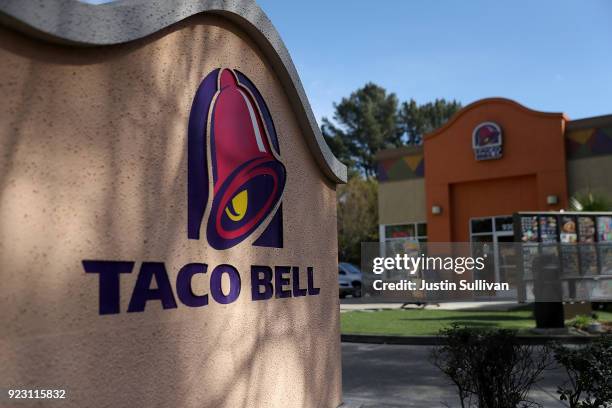 Sign is posted in front of a Taco Bell restaurant on February 22, 2018 in Novato, California. Taco Bell has become the fourth-largest domestic...