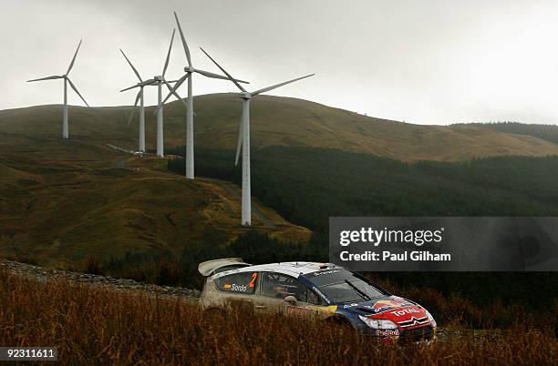 Dani Sordo of Spain and Citroen Total WRT drives the Citroen C4 WRC past a wind farm during stage six of the Wales Rally GB at Myherin on October 23,...