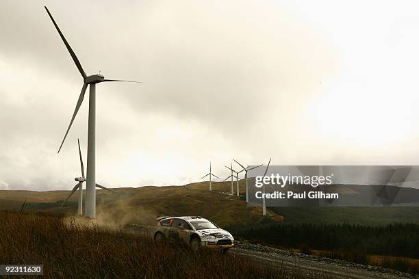 Petter Solberg of Norway and Citroen drives the Citroen C4 WRC past a wind farm during stage six of the Wales Rally GB at Myherin on October 23, 2009...