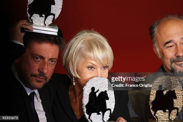 Actor Sergio Castellitto, actress Helen Mirren and director Giorgio Diritti display their awards at the Official Awards Photocall on Day 9 of the 4th...