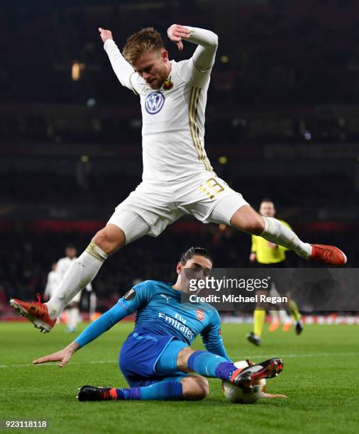 Dennis Widgren of Ostersunds FK evades Hector Bellerin of Arsenal during UEFA Europa League Round of 32 match between Arsenal and Ostersunds FK at...