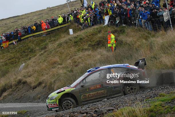 Mikko Hirvonen of Finland and Jarmo Lehtinen of Finland compete in their BP Abu Dhabi Ford Focus during Leg 1 of the WRC Wales Rally GB on October...