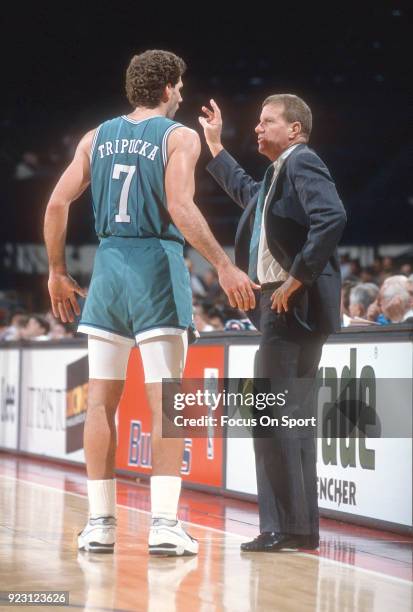 Head coach Dick Harter of the Charlotte Hornets talks with his player Kelly Tripucka against the Washington Bullets during an NBA basketball game...