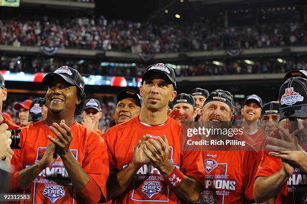 To R: Pedro Martinez, Raul Ibanez and Matt Stairs of the Philadelphia Phillies, clap as the NLCS trophy is presented during Game Five of the National...