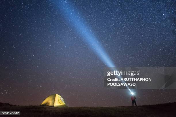 milky way and star galaxy on the sky with camping tent and people with flashlight - flashlight imagens e fotografias de stock