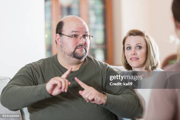 man with family, using sign language - group of people using sign language stock pictures, royalty-free photos & images