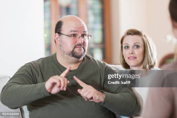 man with family, using sign language - american sign language stock pictures, royalty-free photos & images