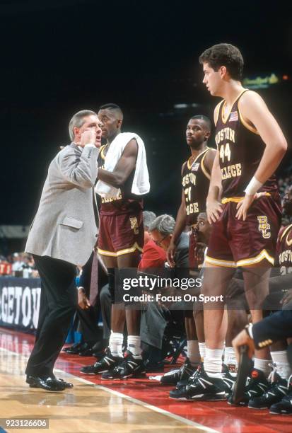 Head coach Jim O'Brien of the Boston College Eagles talks with his players on the bench against the Georgetown Hoyas during an NCAA College...