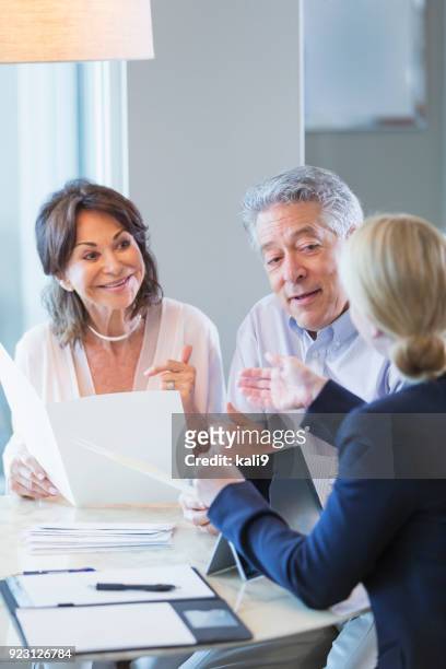 senior couple talking with financial advisor - wealth advisor stock pictures, royalty-free photos & images