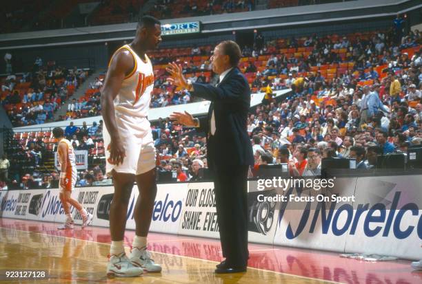 Head coach Lenny Wilkens of the Atlanta Hawks talks with his player Andrew Lang during an NBA basketball game circa 1994 at the Omni Coliseum in...