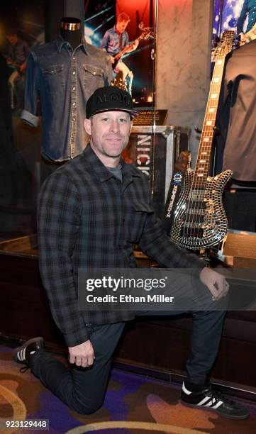 Bassist Mike Kroeger of Nickelback poses next to his Spector custom "mirror" bass during a memorabilia case dedication ahead of the band's five-night...