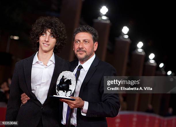Actor Sergio Castellitto and son Pietro Castellitto pose with their awards as they attend the Official Awards Photocall on Day 9 of the 4th...