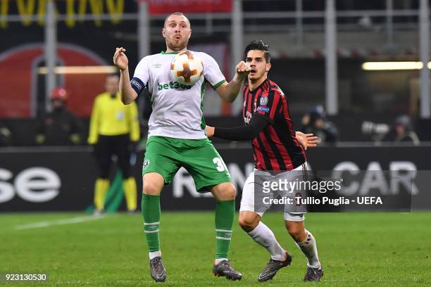 Cosmin Moti of Ludogorets Razgrad controls the ball as Andre Silva of AC Milan tackles during the UEFA Europa League Round of 32 match between AC...