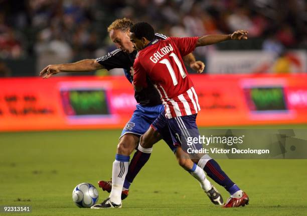Maykel Galindo of Chivas USA challenges Simon Elliott of the San Jose Earthquakes for the ball in the first half during the MLS match at The Home...