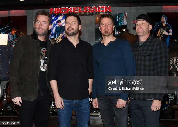 Frontman Chad Kroeger, guitarist Ryan Peake, drummer Daniel Adair and bassist Mike Kroeger of Nickelback attend a memorabilia case dedication ahead...