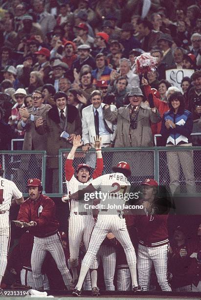 World Series: Rear view of Philadelphia Phillies Bake McBride victorious, walking into dugout and getting greeted by manager Dallas Green and...