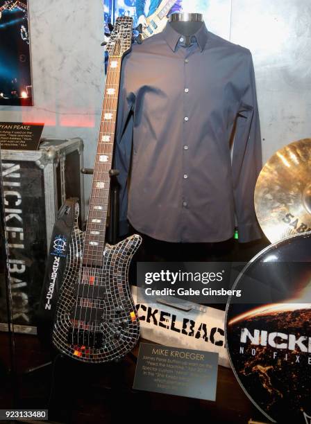 Nickelback bassist Mike Kroeger's Spector custom 'mirror' bass and James Perse shirt are displayed in a memorabilia case after it was unveiled ahead...