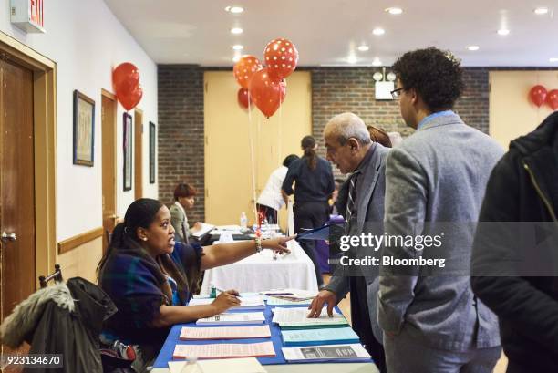 Job seeker, center, speaks with a representative during a Shades of Commerce Career Fair in the Brooklyn borough of New York, U.S., on Saturday, Feb....