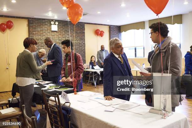 Job seekers speak with representatives during a Shades of Commerce Career Fair in the Brooklyn borough of New York, U.S., on Saturday, Feb. 17, 2018....